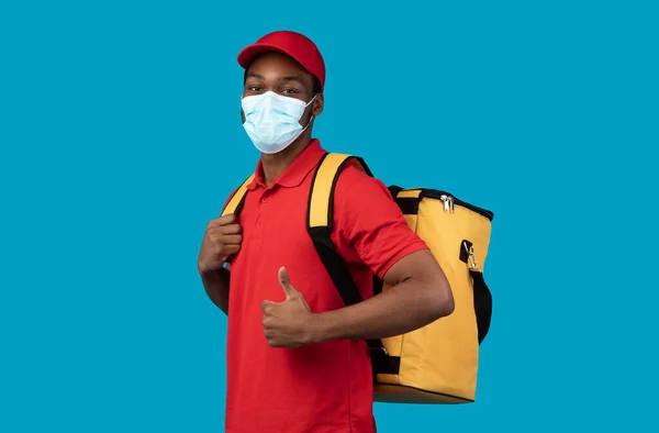 Africano americano repartidor en máscara médica usando bolso termo —  Fotos de Stock