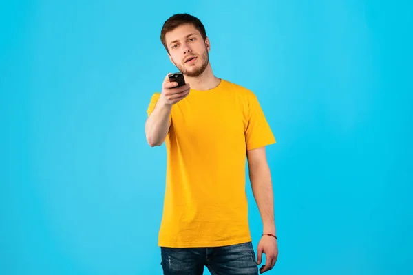 Ragazzo con telecomando isolato su sfondo blu — Foto Stock