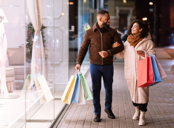 Portrait of happy black couple walking with shopping bags — Stock Photo, Image