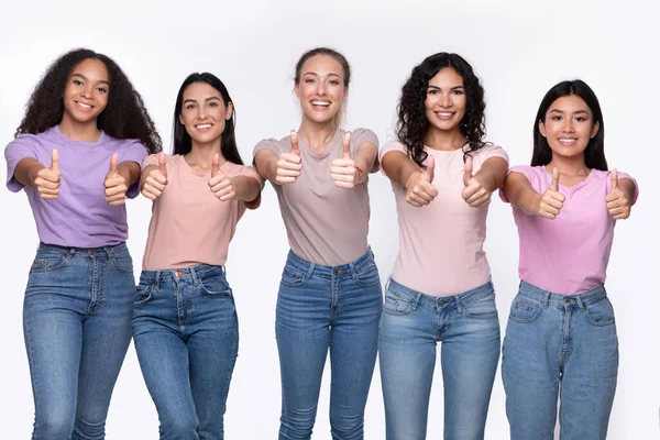 Пять счастливых смешанных женщин Gesturing Thumbs Up Over White Background — стоковое фото