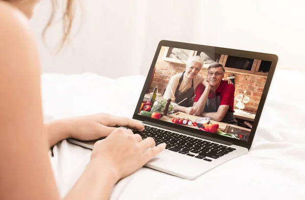 Woman having video call with her old parents, using laptop — Stock Photo, Image