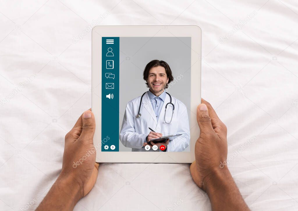 Online Consultation With Doctor Via Video Call On Tablet, POV