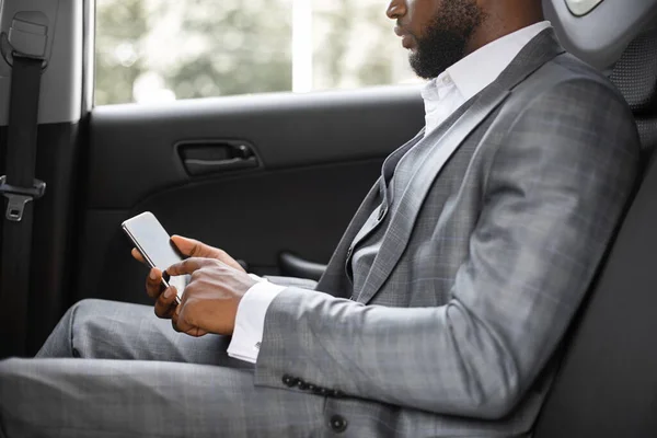 Cropped of black businessman going by car to business meeting