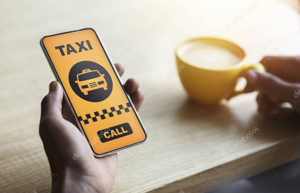 Young female holding smartphone with taxi app interface