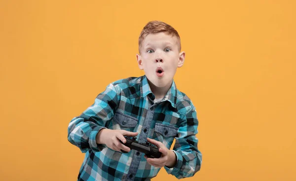 Aufgeregter Junge spielt Videospiel mit Steuerknüppel, Kopierraum — Stockfoto