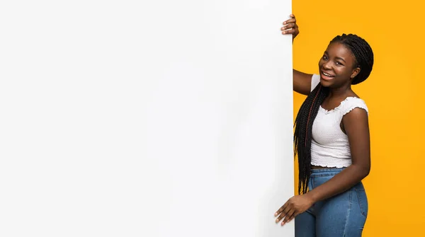 Красивая молодая африканская американка держит белую рекламную доску с пустым местом — стоковое фото