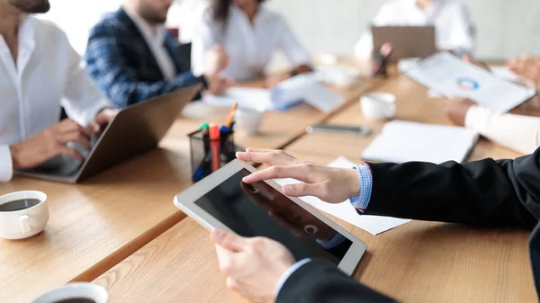 Tablet In Businessmans Hands During Business Meeting In Office, Closeup — Foto de Stock