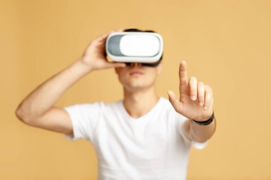 Man playing simulation games with headset and gesturing with his finger