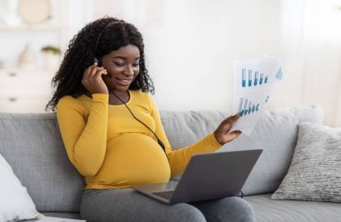 Black pregnant woman freelancer having video conference, working during pregnancy
