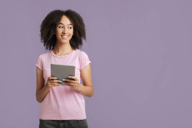 Çalışma ve öğrenim teknolojisi. Gülümseyen bir kadın, elinde tablet, online alışveriş yapıyor.