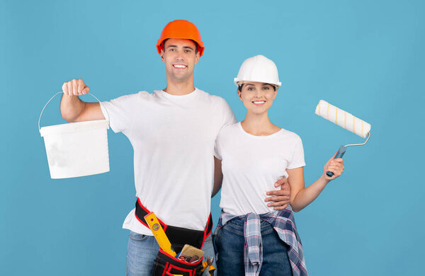 Home Renovation. Portrait of smiling couple with painting tools, ready for repair