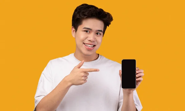 携帯電話の画面とポインティングを示すアジアの男 — ストック写真