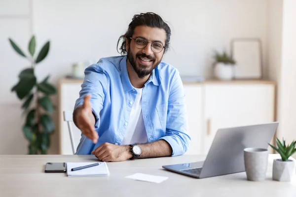 Partnerschaftskonzept. Lächelnder arabischer Unternehmer reicht vor laufender Kamera die Hand — Stockfoto