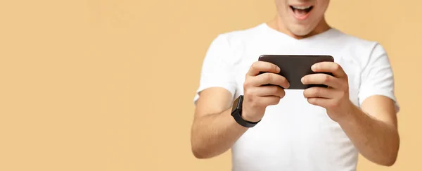 Online games, entertainment and winning. Excited guy with smart watch playing on modern phone — Stock Photo, Image