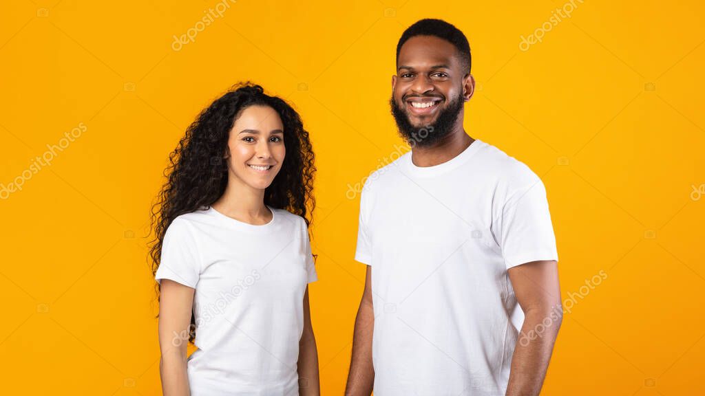 Multiethnic Couple Posing Standing Over Yellow Studio Background, Panorama