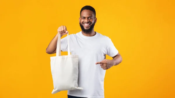 Smiling Black Guy Holding Eco Bag Standing Over Yellow Background — Stock Photo, Image