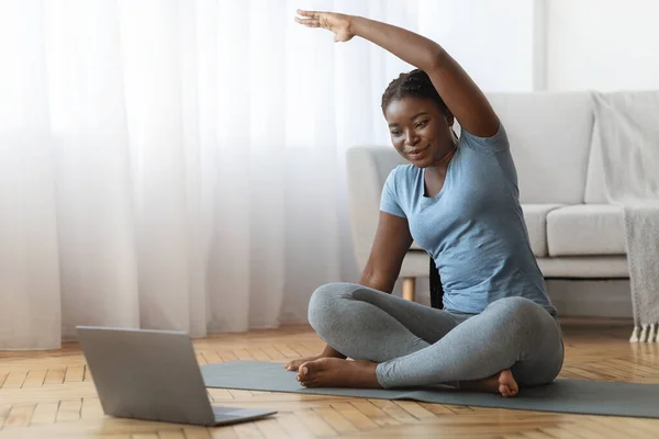 Online Γυμναστική. Χαμογελώντας Black Lady Εκπαίδευση μπροστά από το φορητό υπολογιστή στο σπίτι — Φωτογραφία Αρχείου