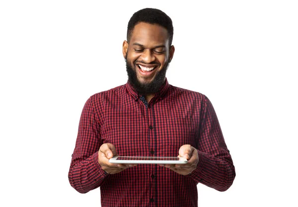 Hombre africano alegre sosteniendo tableta digital de pie sobre fondo blanco —  Fotos de Stock