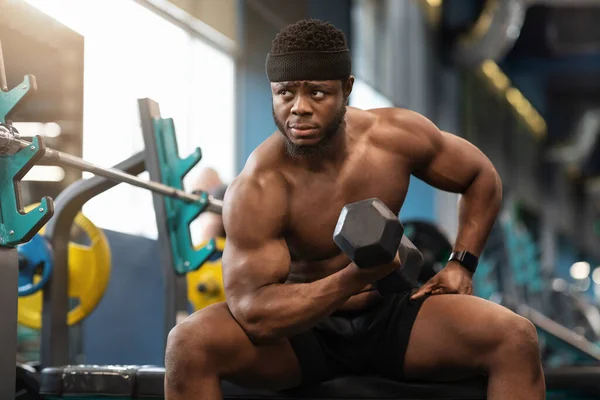 Geconcentreerde Afrikaanse gespierde man die traint met lange halter — Stockfoto