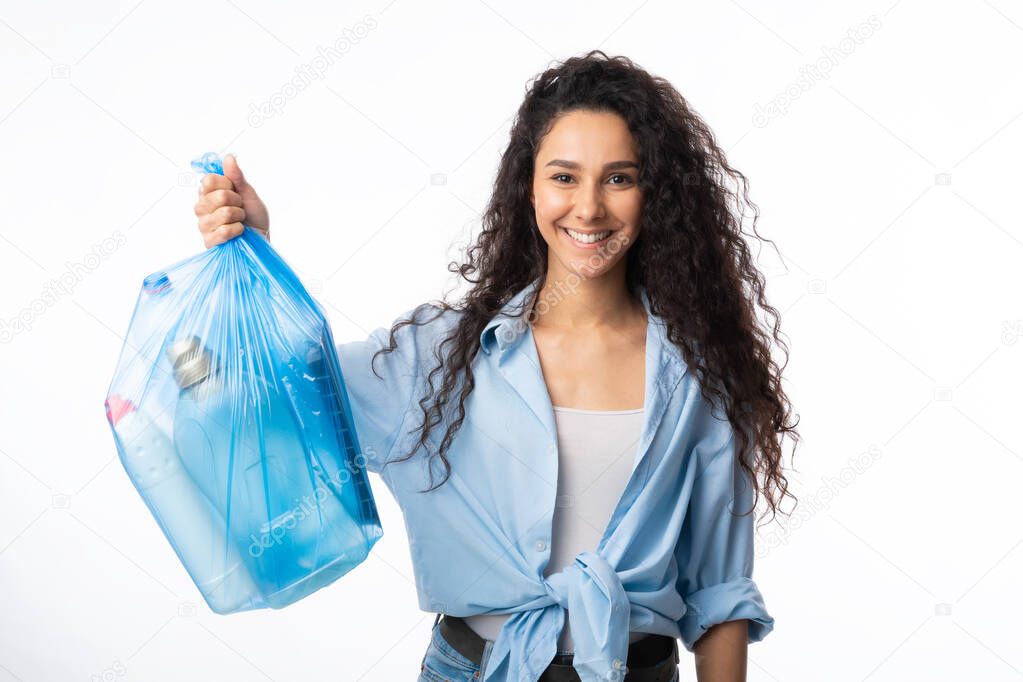 Woman Posing With Plastic Garbage Bag Over White Studio Background