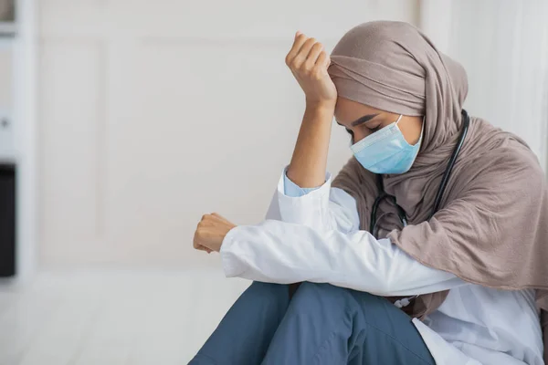 Sad woman doctor in hijab having difficult day at clinic