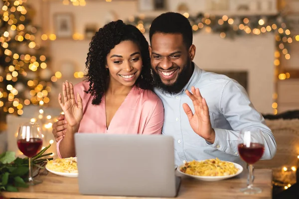 Black man and woman waving to laptop during virtual party — Stock Photo, Image