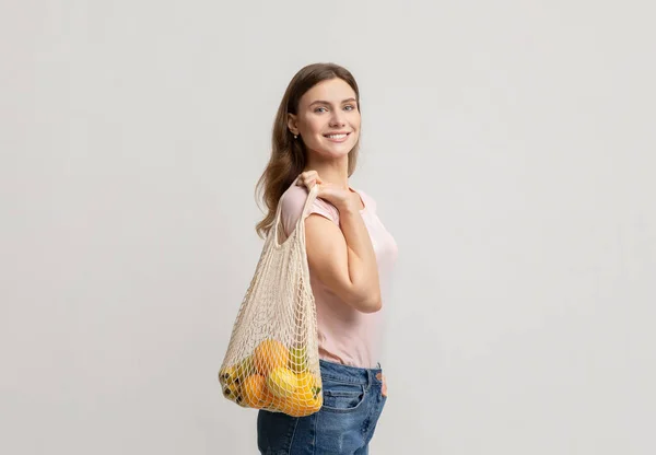 Conceito Zero de Resíduos. Mulher segurando malha Eco saco com frutas e legumes — Fotografia de Stock