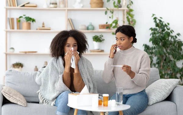 Worry, care and treatment of disease. Weak millennial african american female wipes nose — Stock Photo, Image