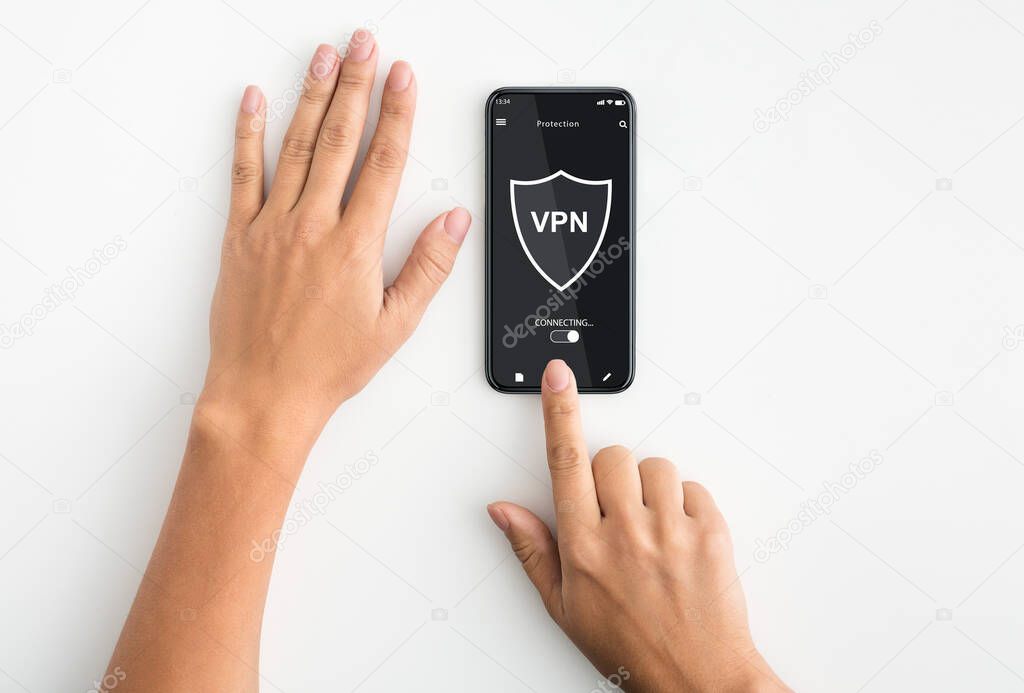 Top view of woman using smartphone with vpn app