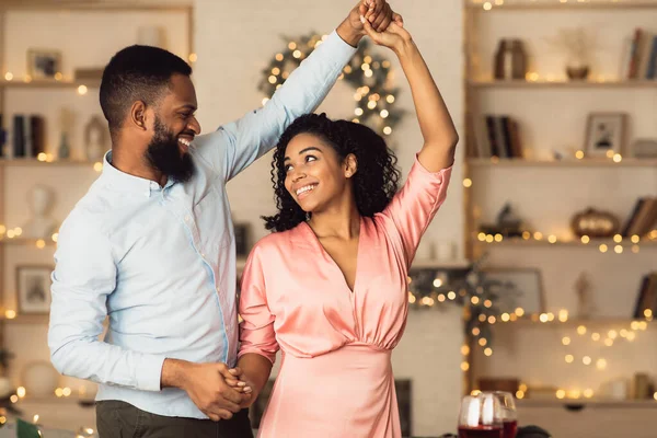 Smiling black man dancing with his woman