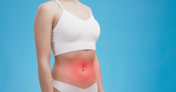 Female period cramps. Woman body with red pulsating belly, blue background — Stock Video