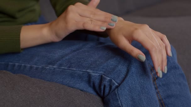 Säsongsbunden hudvård. Närbild skott av ung kvinna som tillämpar återfuktande kräm på händerna, slow motion — Stockvideo