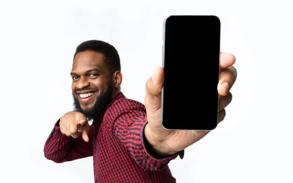 Alegre negro chico mostrando la pantalla del teléfono a la cámara, fondo blanco — Foto de Stock