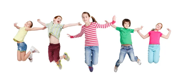 Niños alegres saltando en medio del aire posando sobre fondo blanco —  Fotos de Stock
