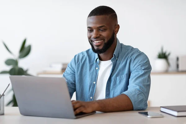Remote Work. Handsome Black Freelancer Guy Working On Laptop At Home Office