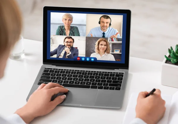 Lady Talking with Colleagues Online via Video Call Sitting Indoors — стоковое фото