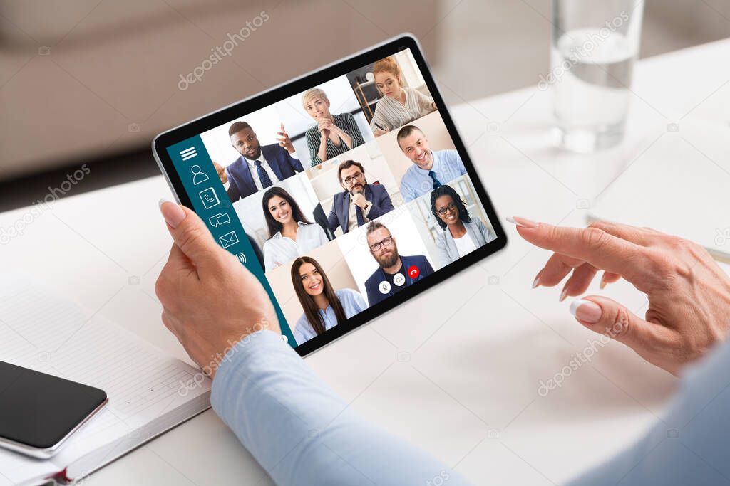 Businesswoman Holding Tablet Having Online Meeting In Modern Office, Cropped