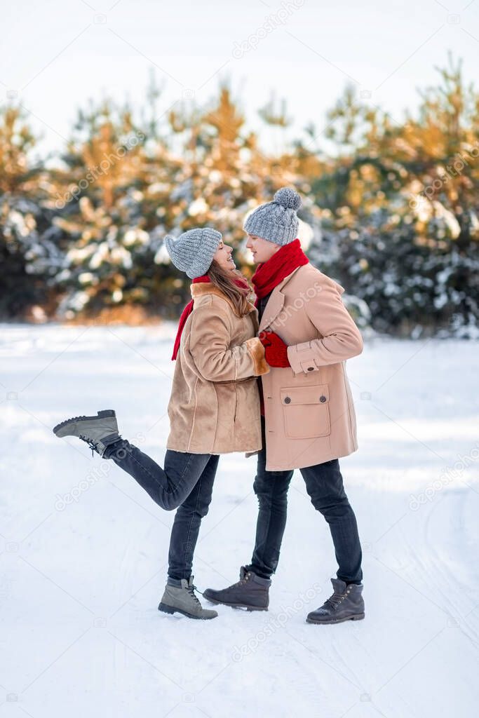 Romantic young couple bonding while walking on winter day