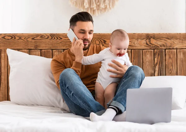 Father Talking On Phone Caring For Baby Working At Home — Stock Photo, Image