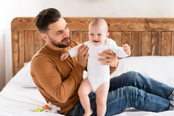 Baby peuter huilen terwijl vader spelen met haar thuis — Stockfoto