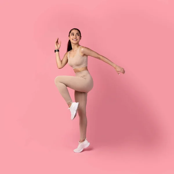 Smiling Young Woman Jumping And Exercising Isolated On Pink Background — Stock Photo, Image