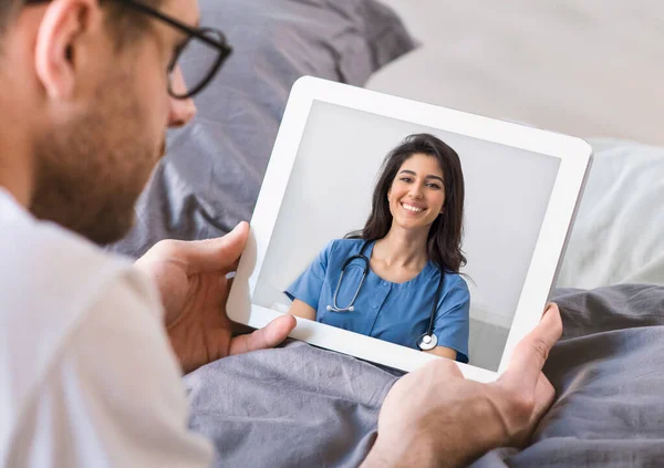 Telemedicine. Man discussing health problem with physician via video call from home — Stock Photo, Image