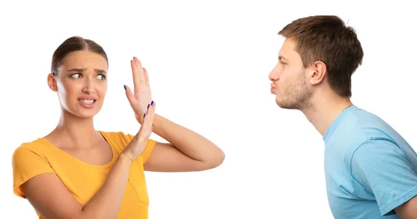 Man trying to kiss confused woman rejecting him — Stock Photo, Image