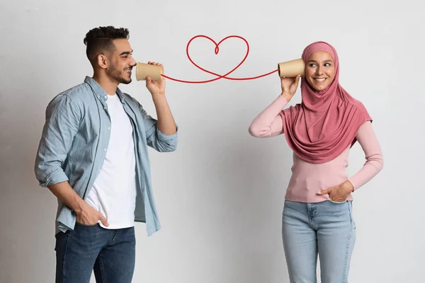 浪漫的男人通过纸杯电话向穆斯林女朋友传达爱意 — 图库照片