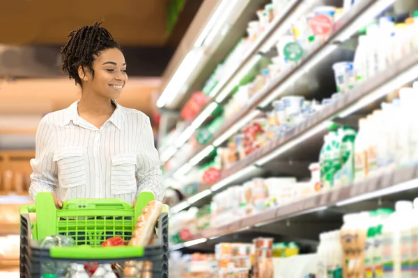 Black Woman Doing Grocery Shopping In Supermarket Buying Food