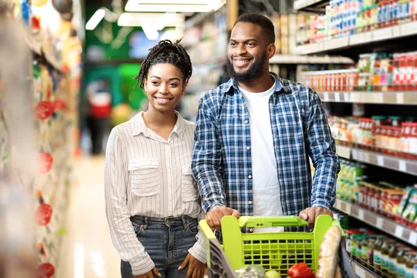 Feliz familia afroamericana haciendo compras en el supermercado juntos —  Fotos de Stock