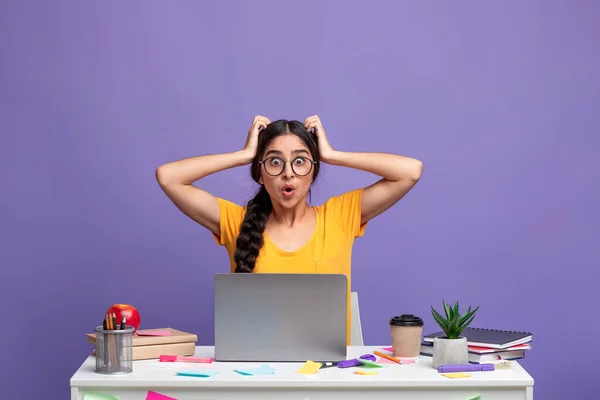 Shocked indian woman looking at camera using laptop — Stock Photo, Image