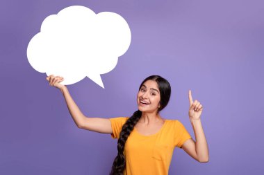 Smiling indian woman pointing finger up hoding speech bubble clipart