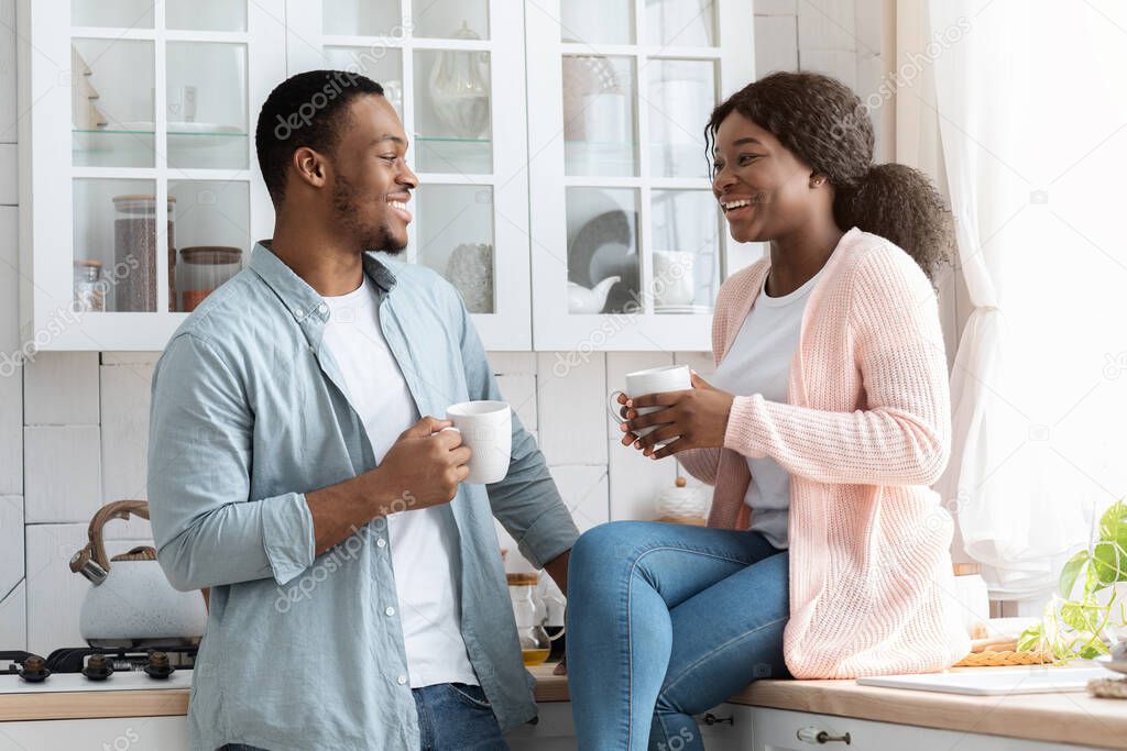 Cheeful African American Spouses Drinking Coffe In Cozy Kitchen