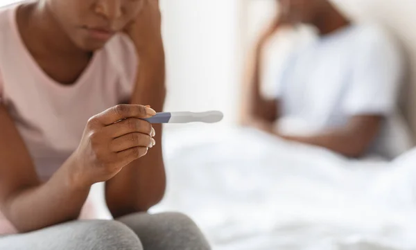 Unrecognizable black woman holding pregnancy test, unintended pregnancy concept — Stock Photo, Image